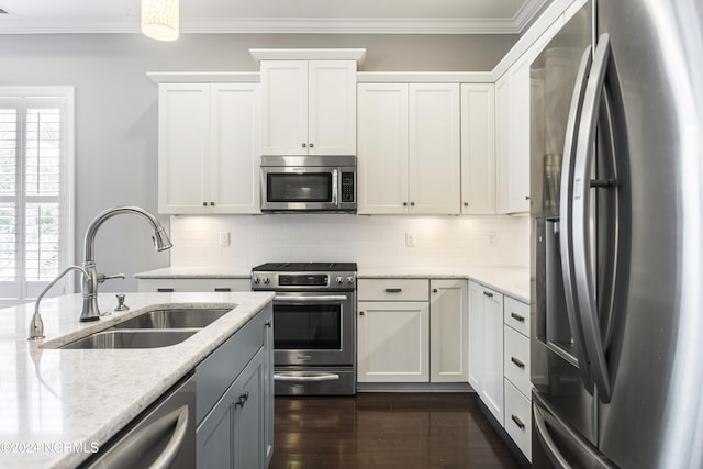 1230 Pinfish Ln, Carolina Beach, NC 28428 - kitchen with stainless steel appliances, crown molding, light stone countertops, white cabinets, and dark wood-type flooring