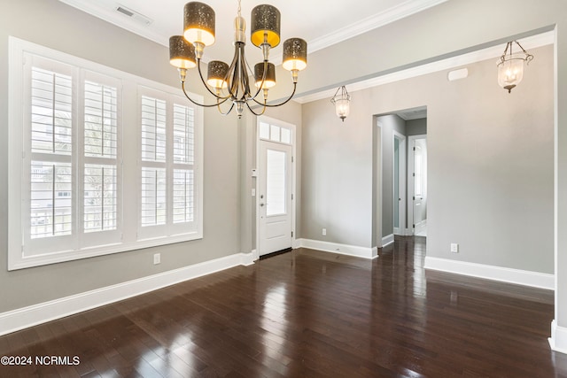 foyer featuring ornamental molding, an inviting chandelier, and dark hardwood / wood-style flooring