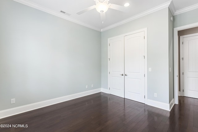 1230 Pinfish Ln, Carolina Beach, NC 28428 - unfurnished bedroom with dark wood-style flooring, a closet, crown molding, and a ceiling fan