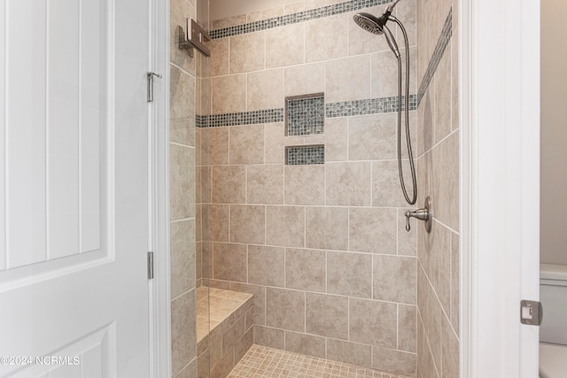 bathroom with tiled shower