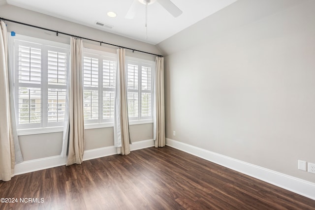 empty room featuring ceiling fan, lofted ceiling, and dark hardwood / wood-style flooring