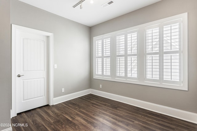 1230 Pinfish Ln, Carolina Beach, NC 28428 - unfurnished room featuring dark wood finished floors and rail lighting