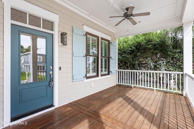 wooden terrace with covered porch and ceiling fan