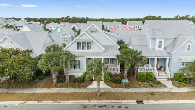 1230 Pinfish Ln, Carolina Beach, NC 28428 - view of front of house featuring a residential view, a porch, and a metal roof