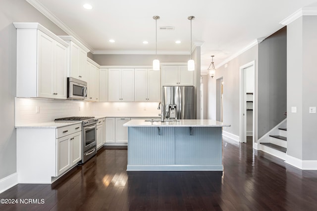 kitchen featuring pendant lighting, white cabinets, a center island with sink, appliances with stainless steel finishes, and dark hardwood / wood-style flooring