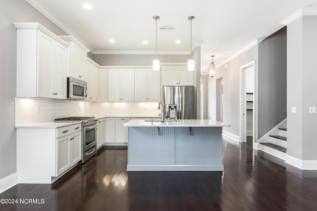 1230 Pinfish Ln, Carolina Beach, NC 28428 - kitchen featuring stainless steel appliances, dark wood-style flooring, decorative backsplash, white cabinets, and a kitchen island with sink
