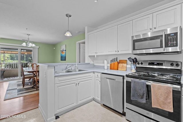 kitchen with stainless steel appliances, light hardwood / wood-style floors, white cabinets, and sink