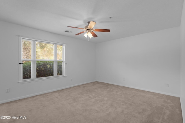 633 Spencer Farlow Dr Unit 12, Carolina Beach, NC 28428 - spare room featuring a ceiling fan, light carpet, and baseboards