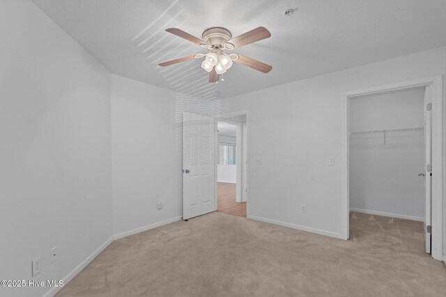 633 Spencer Farlow Dr Unit 12, Carolina Beach, NC 28428 - unfurnished bedroom with carpet floors, a spacious closet, baseboards, a closet, and ceiling fan