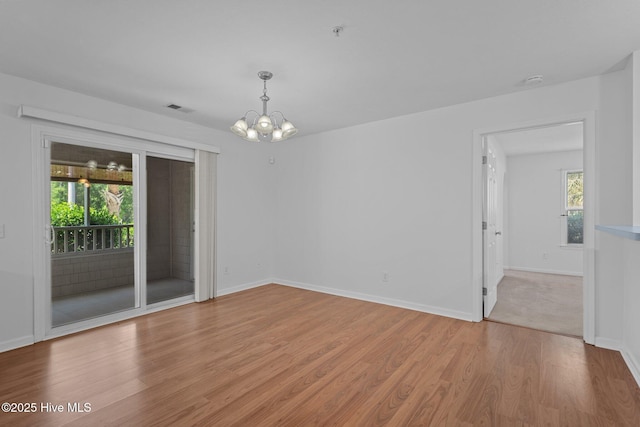 633 Spencer Farlow Dr Unit 12, Carolina Beach, NC 28428 - unfurnished room with light wood finished floors, a chandelier, baseboards, a smoke detector, and a pendent fire sprinkler