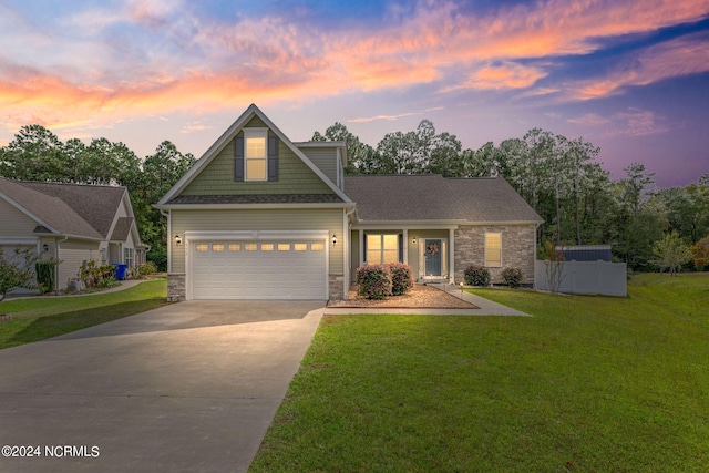 craftsman-style house featuring a yard and a garage