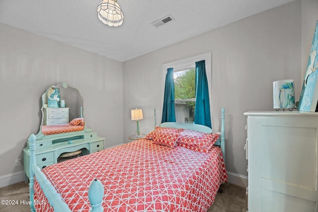 carpeted bedroom featuring a textured ceiling