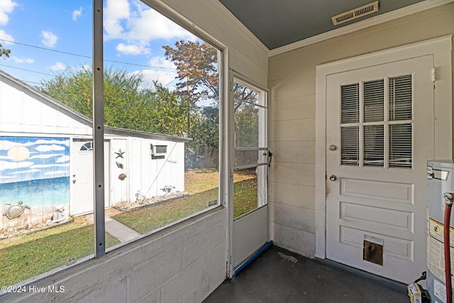 unfurnished sunroom with gas water heater