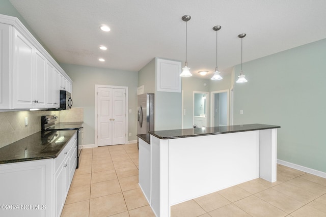 kitchen featuring stainless steel fridge, black electric range oven, white cabinetry, and hanging light fixtures