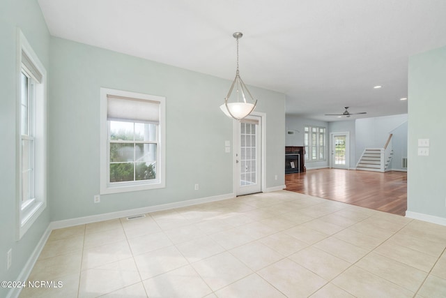499 Ward Rd, Swansboro, NC 28584 - empty room with baseboards, visible vents, stairs, ceiling fan, and light tile patterned floors