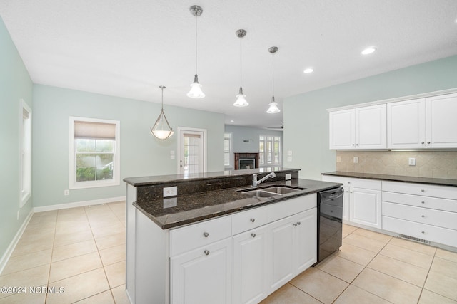 499 Ward Rd, Swansboro, NC 28584 - kitchen featuring tasteful backsplash, black dishwasher, a sink, and light tile patterned floors