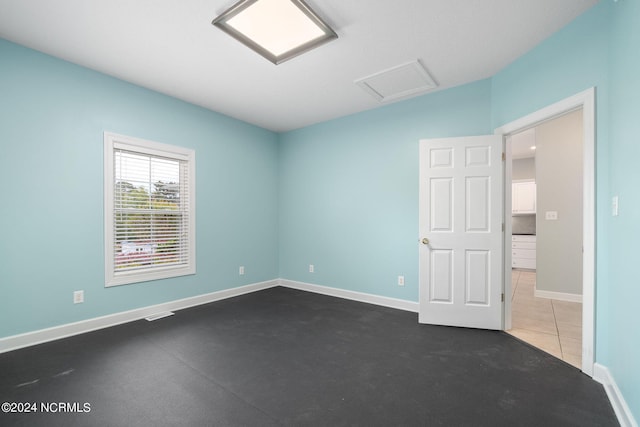 499 Ward Rd, Swansboro, NC 28584 - empty room featuring attic access, vaulted ceiling, and baseboards