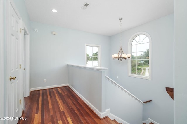 499 Ward Rd, Swansboro, NC 28584 - hall with visible vents, a healthy amount of sunlight, a notable chandelier, and an upstairs landing