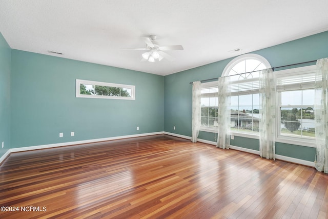 unfurnished room featuring a textured ceiling, hardwood / wood-style flooring, and ceiling fan