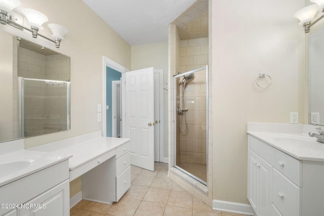 bathroom featuring vanity, tile patterned floors, a textured ceiling, and an enclosed shower