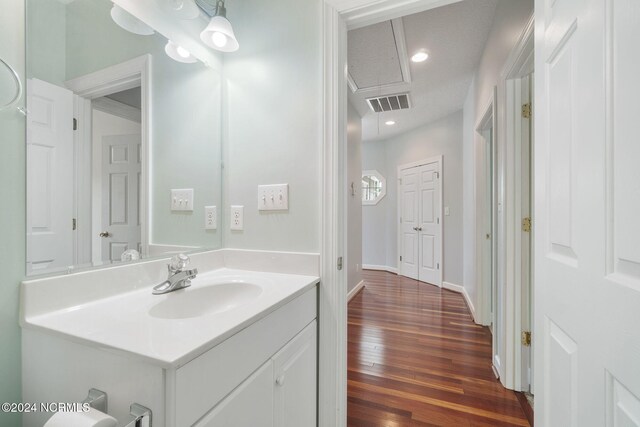 499 Ward Rd, Swansboro, NC 28584 - bathroom with recessed lighting, hardwood / wood-style floors, visible vents, vanity, and baseboards