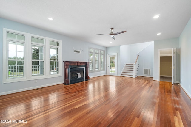 499 Ward Rd, Swansboro, NC 28584 - unfurnished living room featuring wood finished floors, visible vents, stairs, and ceiling fan