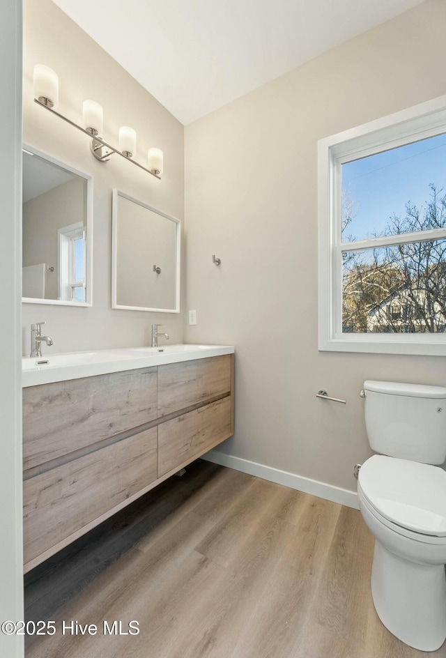 bathroom featuring hardwood / wood-style floors, vanity, and toilet