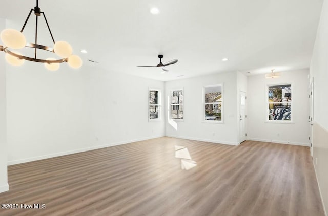 unfurnished living room with ceiling fan and hardwood / wood-style flooring