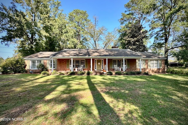 single story home featuring a front lawn and covered porch