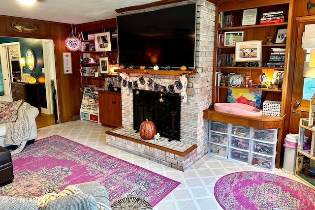 tiled living room featuring a fireplace and wooden walls