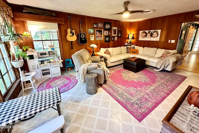 living room with wooden walls and ceiling fan