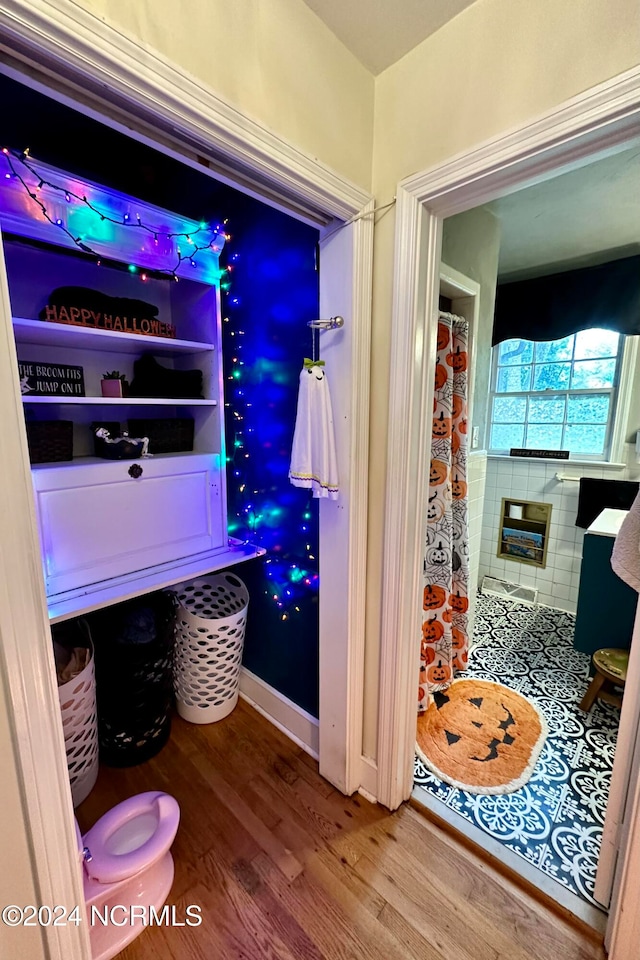 bathroom with wood-type flooring and walk in shower