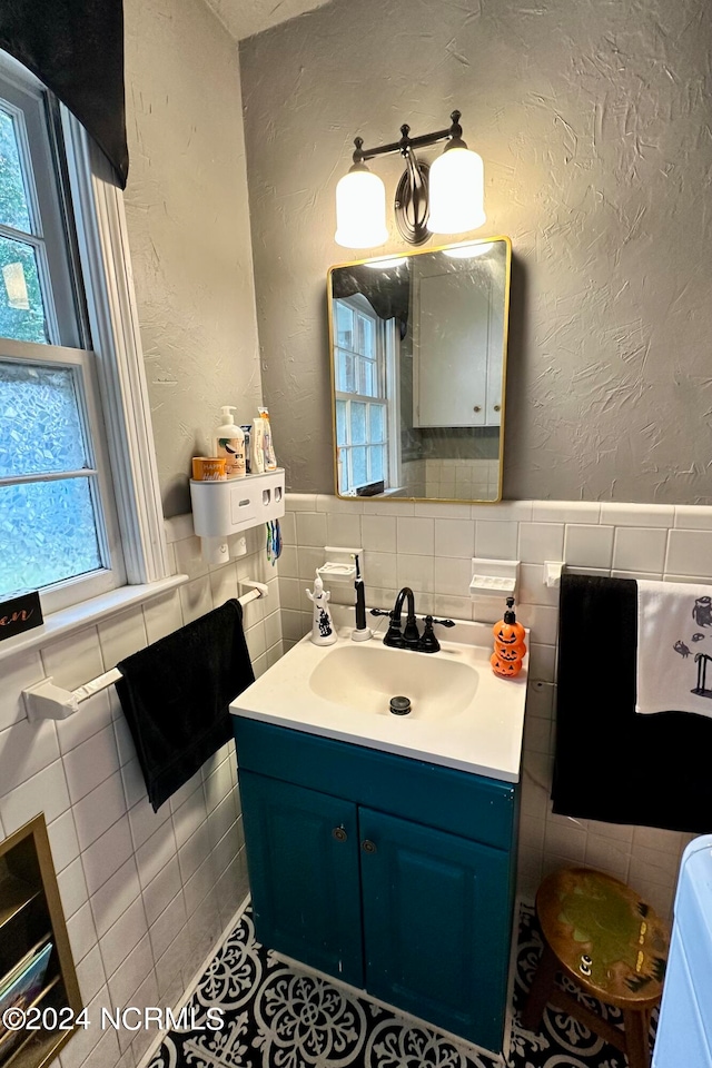 bathroom featuring tile patterned floors, vanity, and tile walls