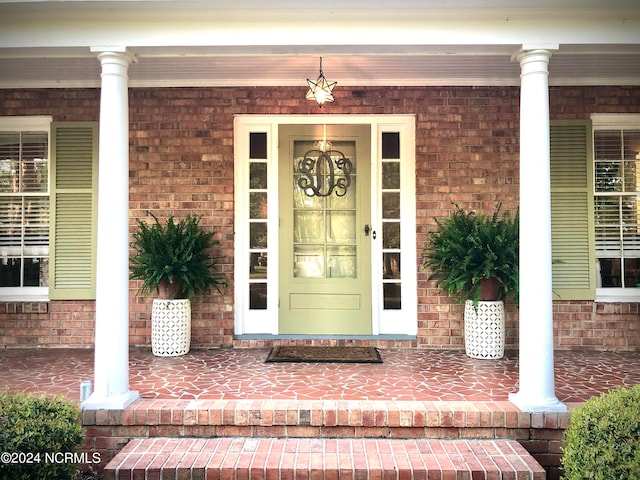 view of exterior entry with covered porch