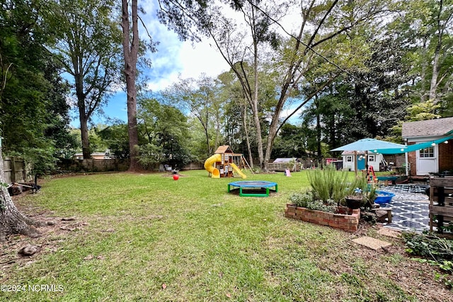 view of yard featuring a playground and a patio area