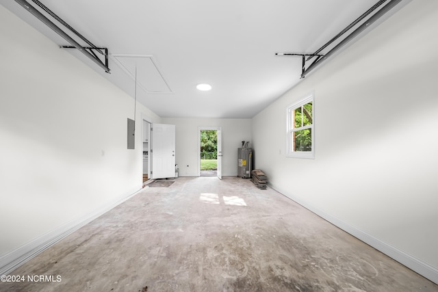 garage with electric water heater and electric panel