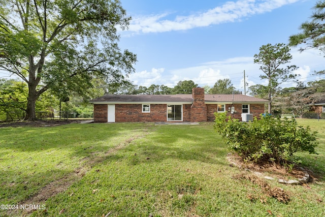 rear view of property with a yard