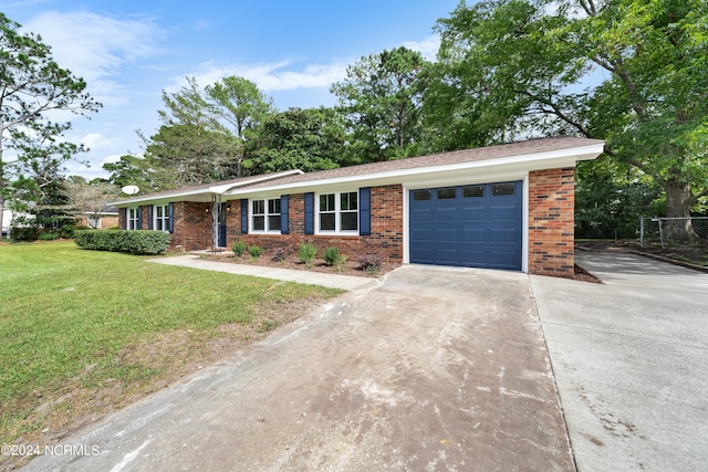 ranch-style house with a garage and a front lawn