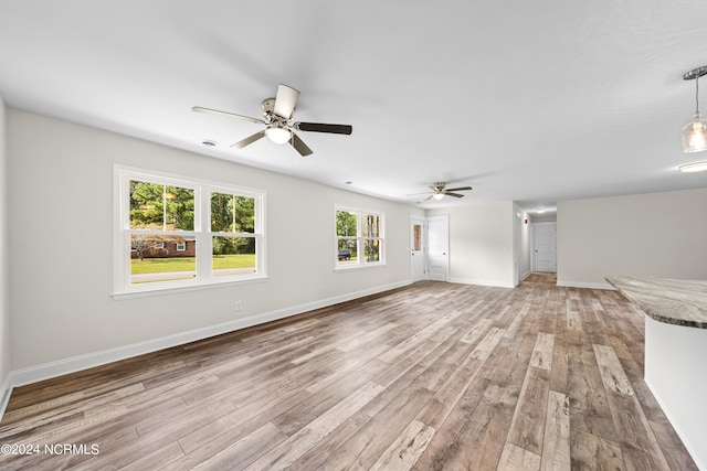 unfurnished living room with ceiling fan and light hardwood / wood-style floors