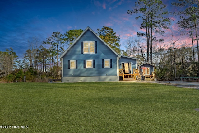 view of front of home featuring a deck, a front lawn, and crawl space