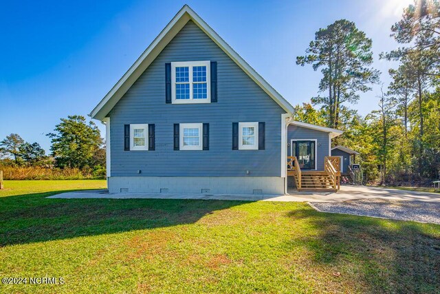 rear view of property featuring crawl space and a yard