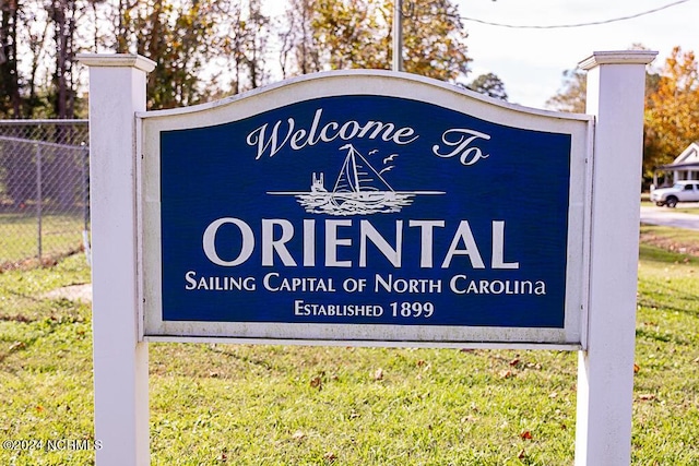 community / neighborhood sign with fence