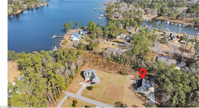 birds eye view of property with a water view