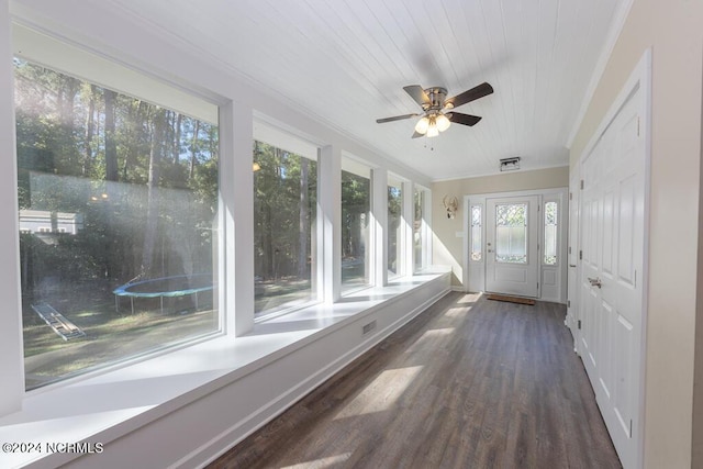 unfurnished sunroom with wooden ceiling and a ceiling fan