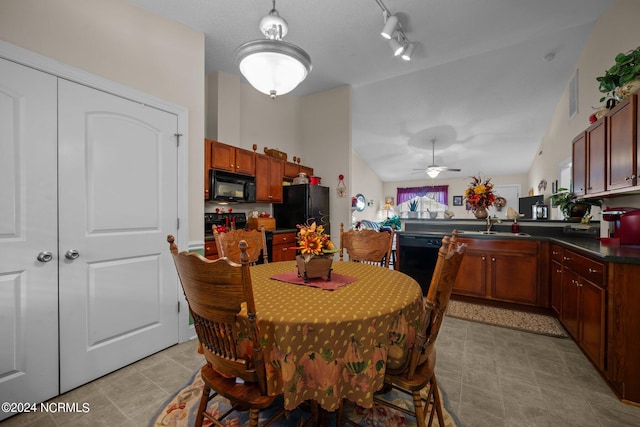 dining space with ceiling fan, vaulted ceiling, and sink