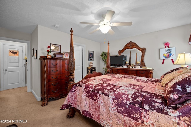 bedroom featuring ceiling fan, light colored carpet, and a textured ceiling