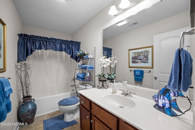 full bathroom with tile patterned flooring, tub / shower combination, toilet, vanity, and a textured ceiling