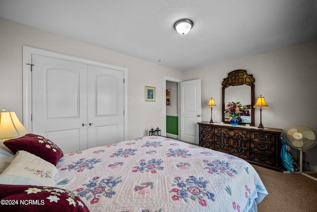 bedroom featuring a textured ceiling, a closet, and carpet flooring