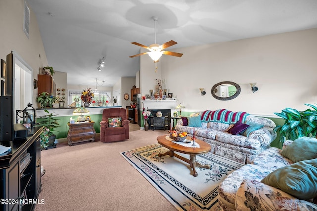 carpeted living room featuring vaulted ceiling and ceiling fan