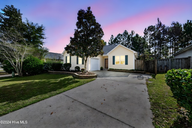 ranch-style house with a lawn and a garage